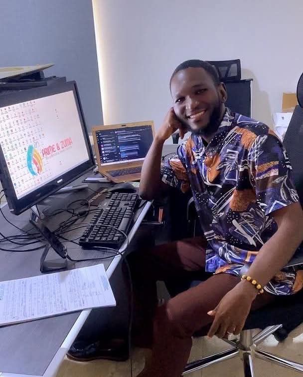 Samson at desk with design work